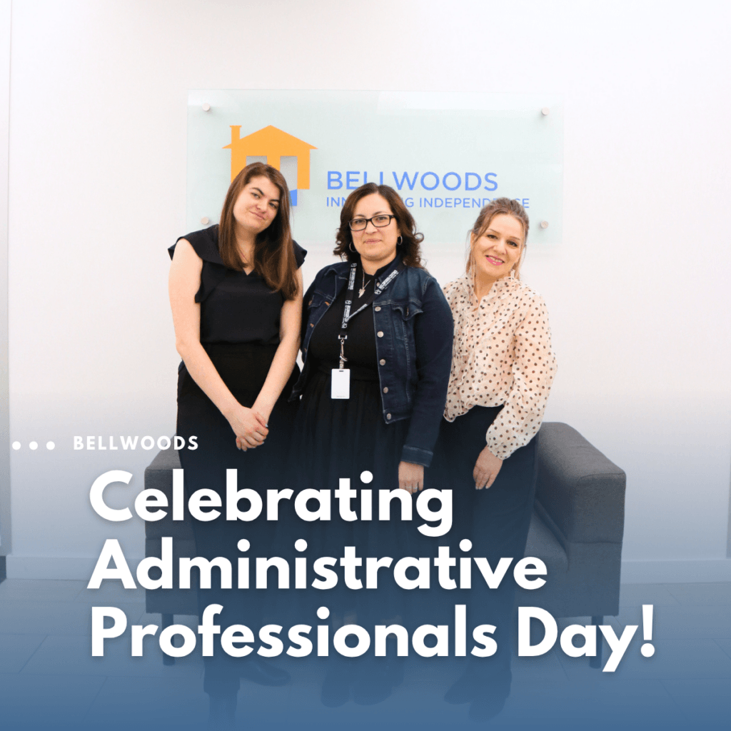 Photo of Bellwoods Administrative staff standing together with the banner " celebrating administrative professionals day!"