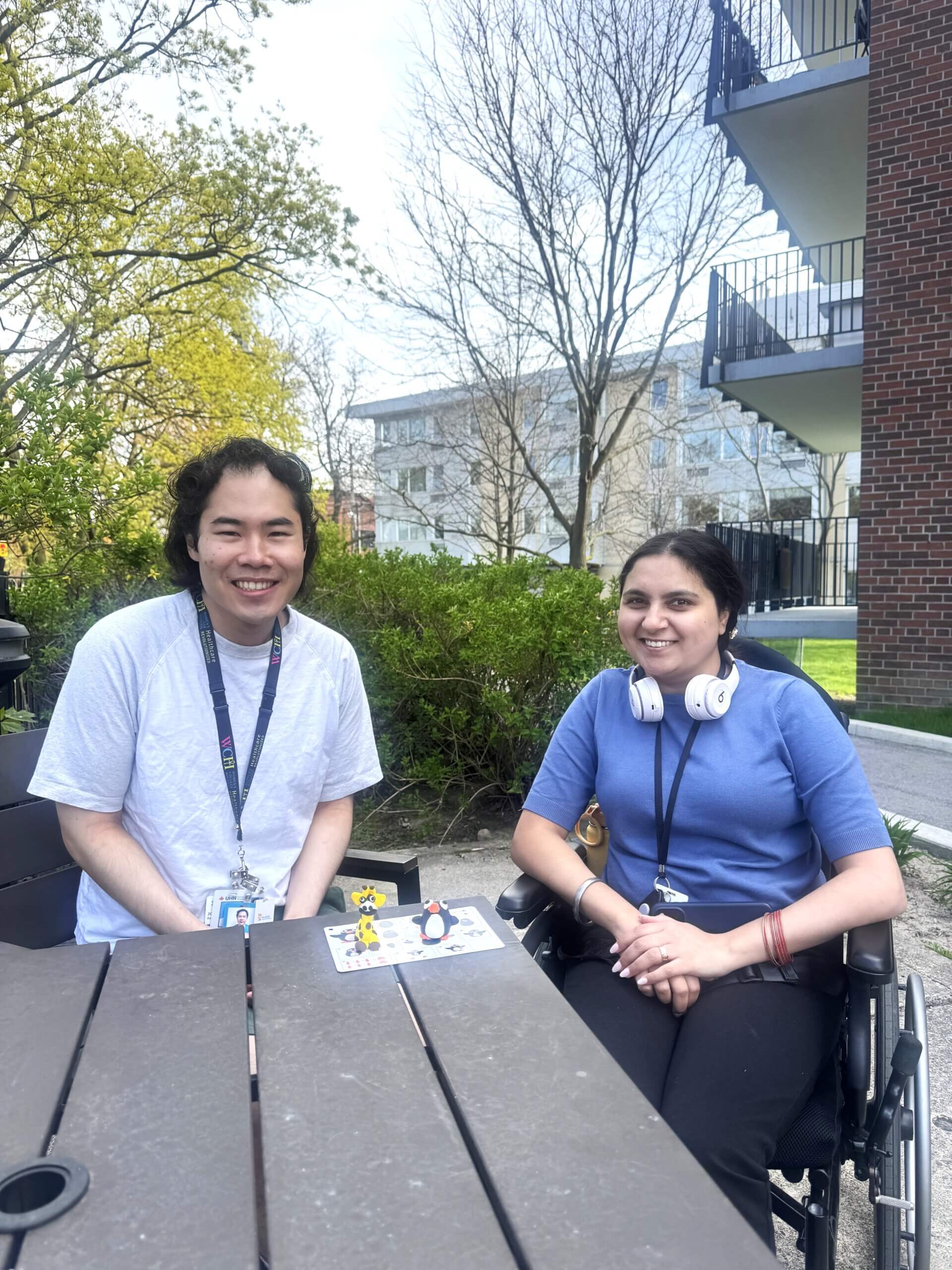 Two people sitting together smiling.